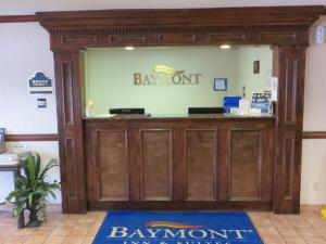 a welcoming entrance to a banyonworth pharmacy with a sign above the door at Baymont by Wyndham Kalamazoo West in Kalamazoo