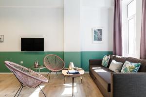a living room with a couch and two chairs at Boutique Central Apartments Acropolis View in Athens