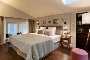a bedroom with a large white bed in a room at Royal Madeleine Hotel & Spa in Paris