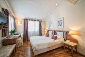 a hotel room with a bed and a television at B&B Hotel Firenze Laurus Al Duomo in Florence