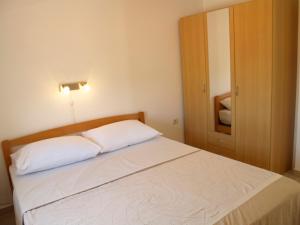 a bedroom with a bed and a cabinet with a mirror at Villa Majer in Preko