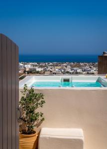 a view of a swimming pool from a balcony at Nalas Suites in Emporio Santorini