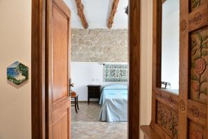 a bedroom with a bed in a room at Hotel Goloritzé in Baunei