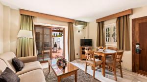 a living room with a couch and a table at Macdonald Villacana Resort in Estepona