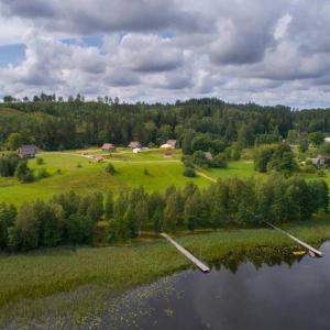 an aerial view of a field and a lake at Mežezera stāsts in Pļaviņas