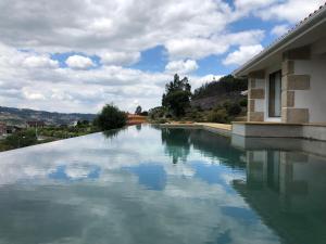 a large pool of water next to a building at BHDouro in Baião