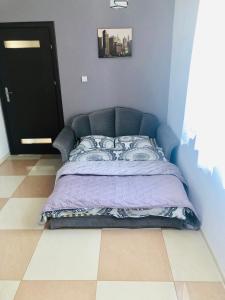 a bed in a bedroom with a blue wall at Mountain and Lake Views beautiful Miedzybrodzie in Międzybrodzie Bialskie