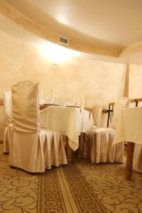 a dining room with white tables and chairs at Ekran Hotel in Lviv