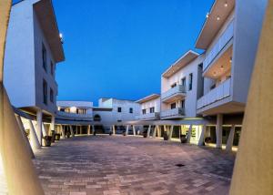 un cortile vuoto di un edificio di notte di La Corte di Leuca Residence & SPA a Leuca