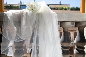 a wedding veil and a bouquet on a table at Genova46 Suites & Rooms in Genoa