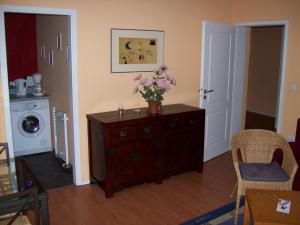 a living room with a dresser with flowers on it at Miróbile in Berlin