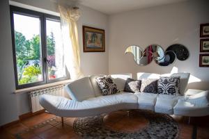 a living room with a white couch and a window at Bed and breakfast Ellera Viterbo in Viterbo