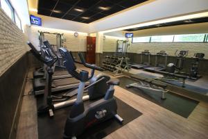 a gym with several treadmills and cardio machines at Hotel Maria Cristina in Mexico City