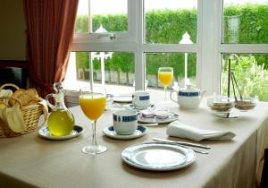 a table with glasses of orange juice and drinks on it at Hotel Castro in Santiago de Compostela