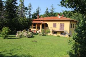 ein Haus auf einem Hügel mit einem Hof in der Unterkunft La Valle De' Medici in Barberino di Mugello