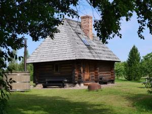 a log cabin with a chimney on top of it at Vilki in Ventspils