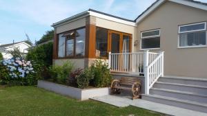a small house with a porch and glass doors at Seaclusion in St Austell