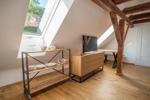 a attic living room with a skylight and a tv at Oficyna Krobielowice in Kąty Wrocławskie