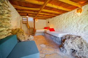 a bedroom with a bed and a stone wall at Canto del Agua Ecolodge in Comitán +22 photos