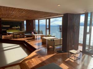 a living room with a view of the ocean at Hotel Eco Max in San Carlos de Bariloche