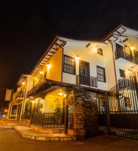 a large white building with lights on it at night at Boroni Palace Hotel in Ouro Preto