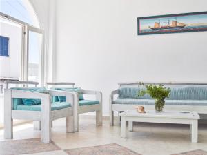 a living room with two chairs and a table at Londos Hotel in Piso Livadi