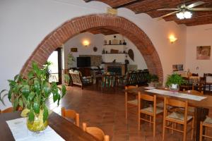 a living room with an archway and tables and chairs at Agriturismo Marruchetone Vecchio in Marsiliana