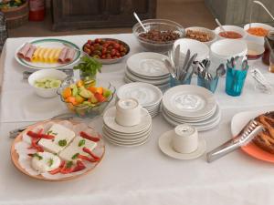 a white table with plates and bowls of food at Londos Hotel in Piso Livadi +95 photos