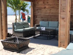 a patio with two chairs and a table on the beach at ICONA Diamond Beach in Wildwood Crest