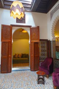 a living room with a couch and a chandelier at Dar Fama in Tétouan