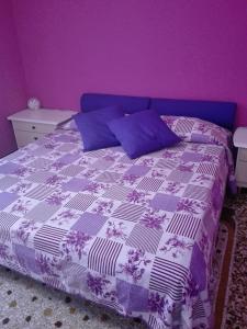 una camera da letto viola con un letto con parete viola di La Casa di Rosco a Genova
