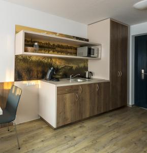 a kitchen with a sink and a counter top at Boarding & HOUSE T24 in Bad Wurzach