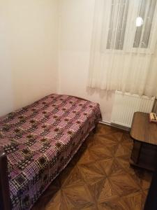 a bedroom with a bed and a window at Guest House Adelina in Mestia