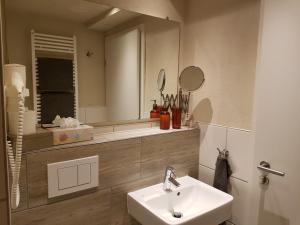a bathroom with a sink and a mirror at Ferienwohnung Oliver in Fritzlar +26 photos