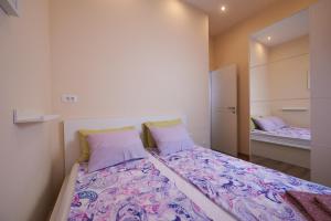 a small bedroom with a bed with a mirror at Apartman Nina in Split