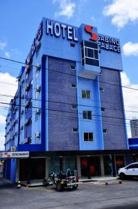 a hotel with a motorcycle parked in front of it at Hotel Sabino Palace in Mossoró