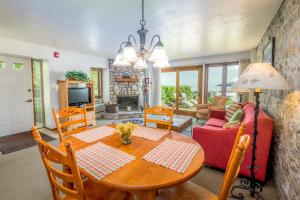 a dining room with a table and a couch at Harbor Guest House in Fish Creek