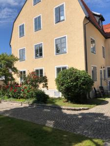 a house with a brick driveway in front of it at Apartments Strandgatan Visby in Visby