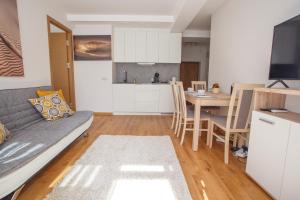 a living room with a couch and a table at Vytauto 801 in Palanga