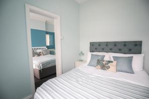 a bedroom with a large bed and a mirror at The Gables Hotel in Blackpool