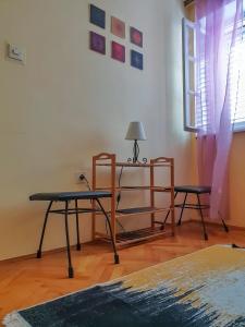 a room with two chairs and a table and a lamp at Old Town Point in Budva +8 photos