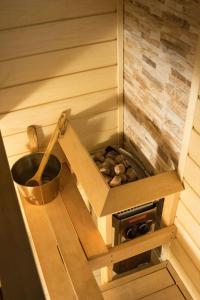 a sauna with a wood stove in a room at LiisuPesa Apartment with Sauna and Garden in Pärnu