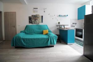 a bedroom with a bed with a green blanket at Apartment Kala in Kaštela