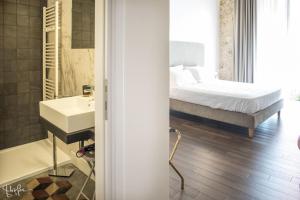 - Baño con dormitorio con cama y lavamanos en Arcipelago 37, en Cagliari
