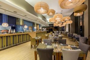 a restaurant with tables and chairs and chandeliers at Enjoy Coquimbo in Coquimbo