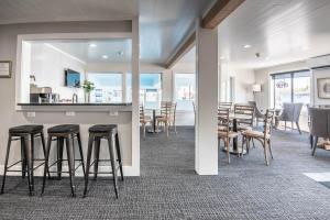 a room with a bar and some chairs and tables at 102 Pointes North Inn in Charlevoix