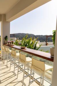 a balcony with a long table and chairs at YaChara Villa in Kissamos