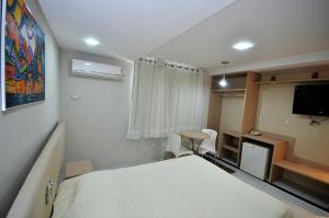 Un pat sau paturi într-o cameră la Hotel Sabino Palace