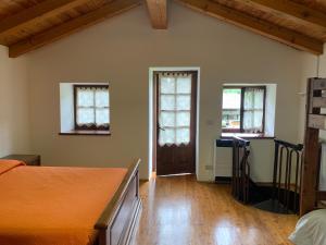 a bedroom with a bed and two windows at Il vecchio mulino in Introd