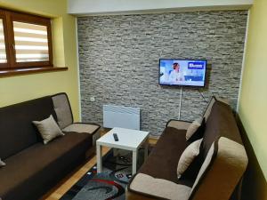 Televízia a/alebo spoločenská miestnosť v ubytovaní APARTAMENT ELIZABETH
